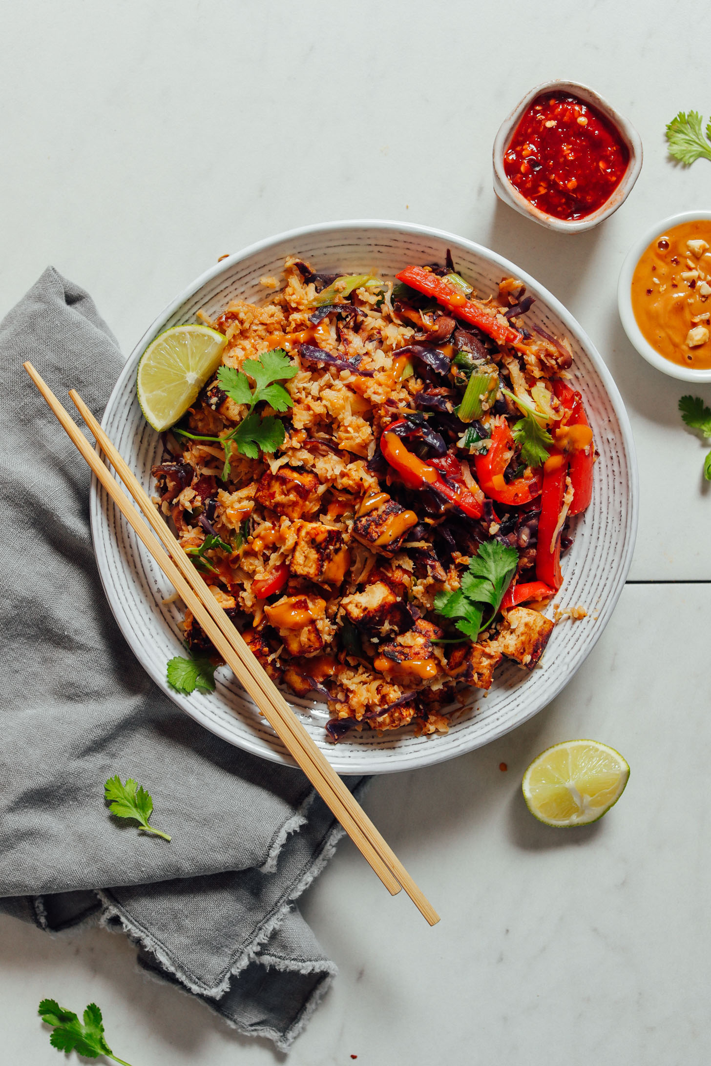 Chopsticks resting on a big bowl of our Tofu Stir Fry for a quick lunch