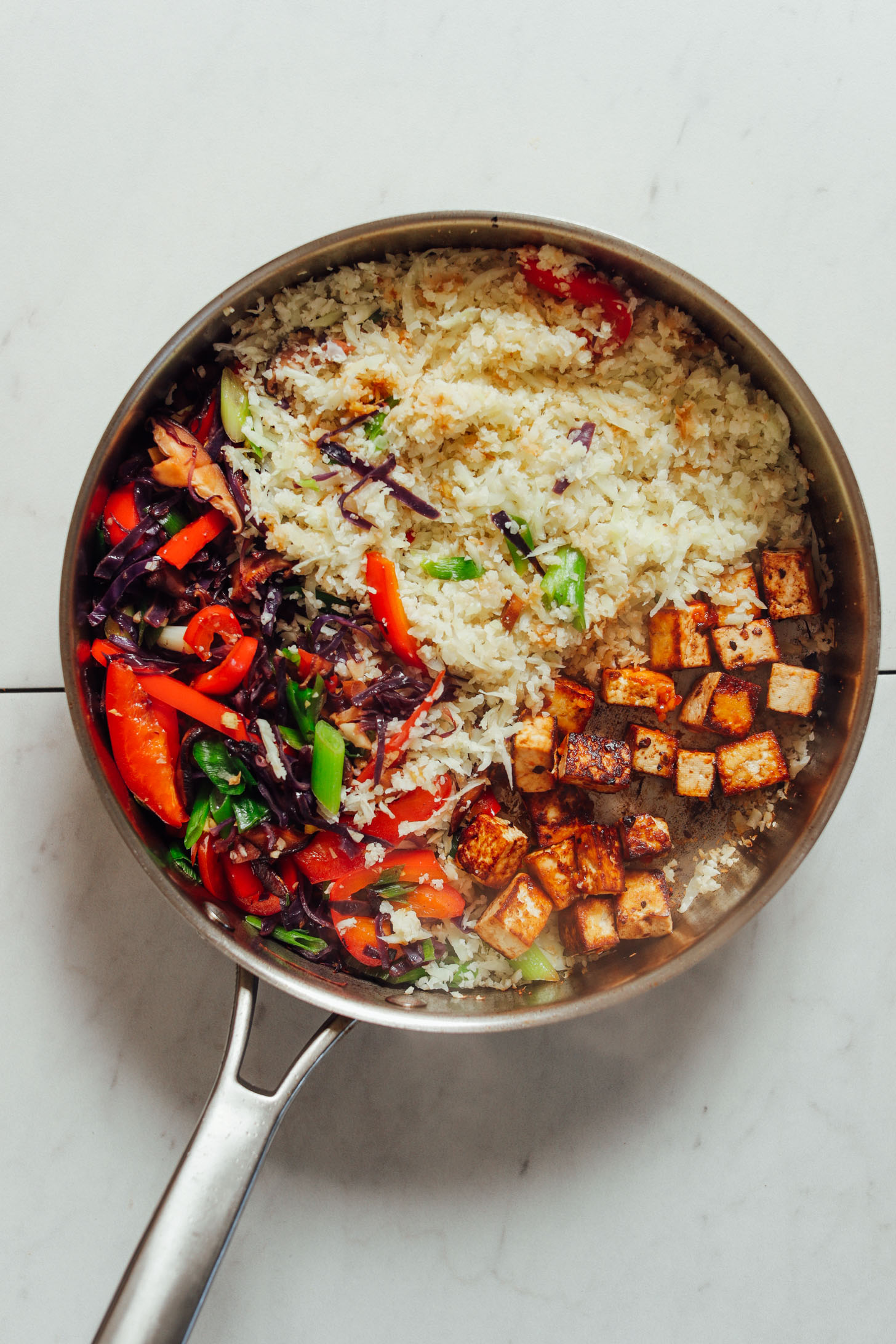 Big pan of tofu, riced cauliflower, and veggies for a delicious plant-based lunch