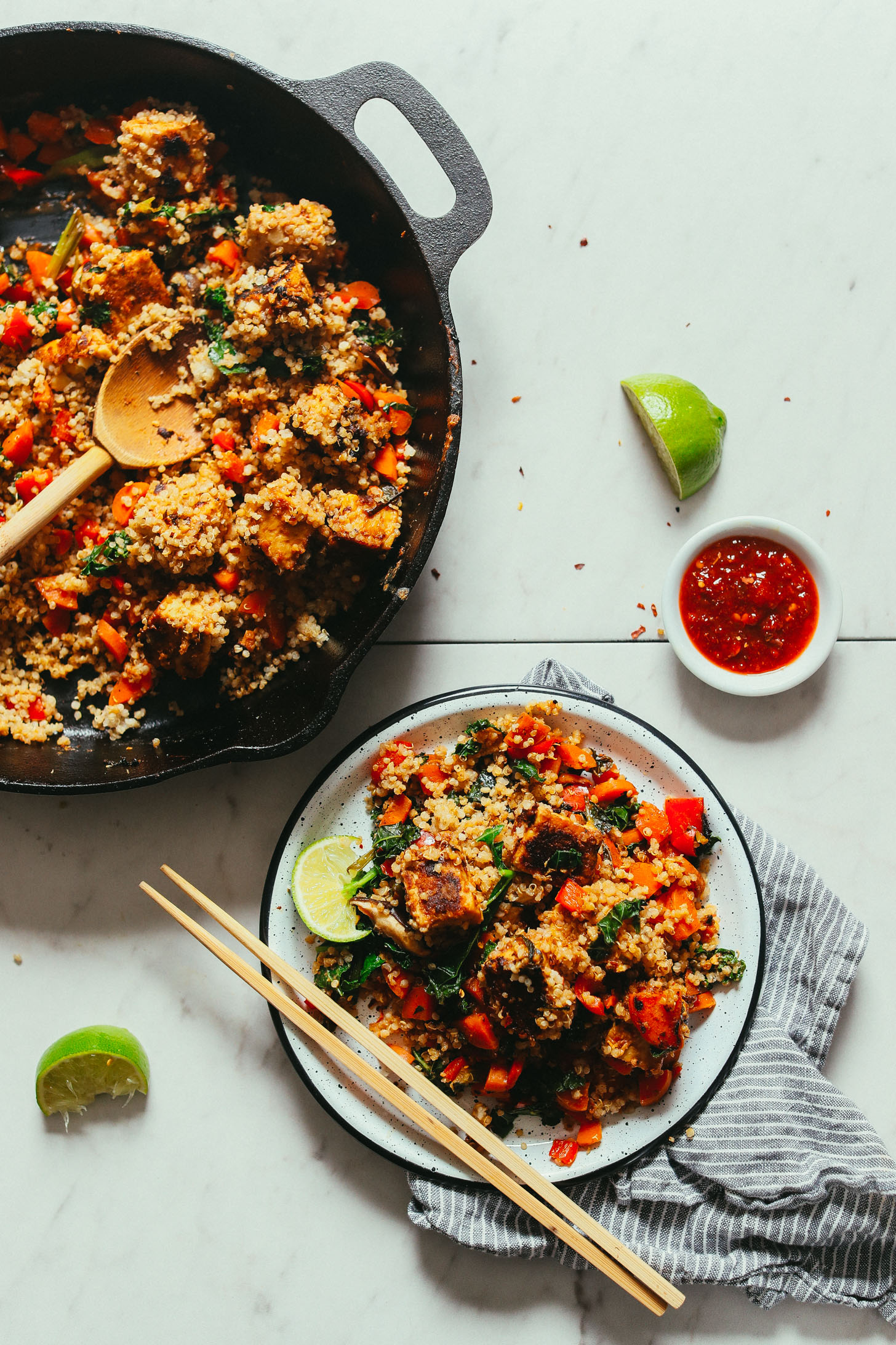 Plate and skillet filled with Vegetable Tempeh Stir Fry for a gluten-free vegan dinner