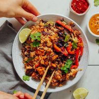 Using chopsticks to grab a bite of our 20-Minute Tofu Stir Fry recipe