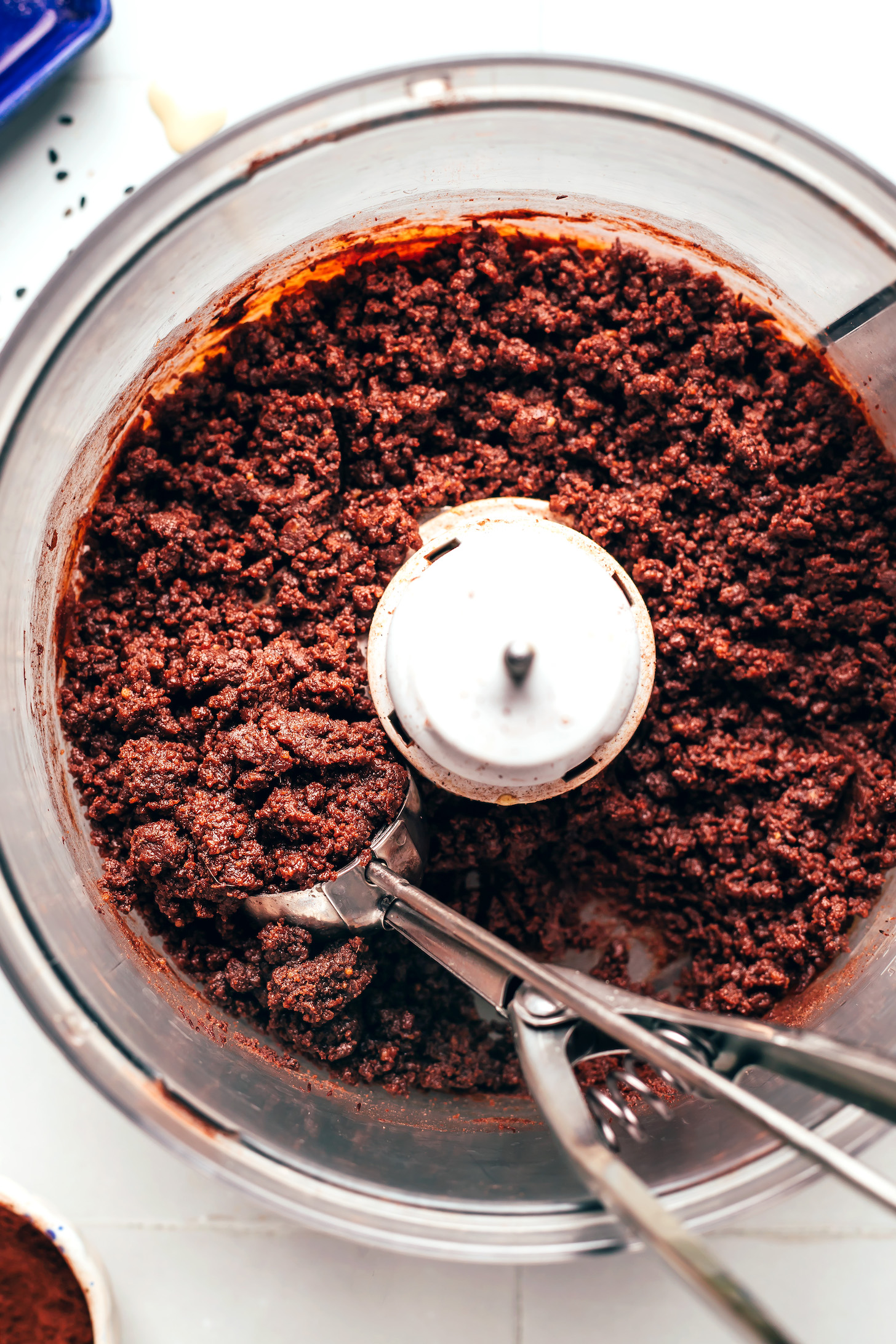 Cookie scoop in a food processor of chocolate tahini truffle dough