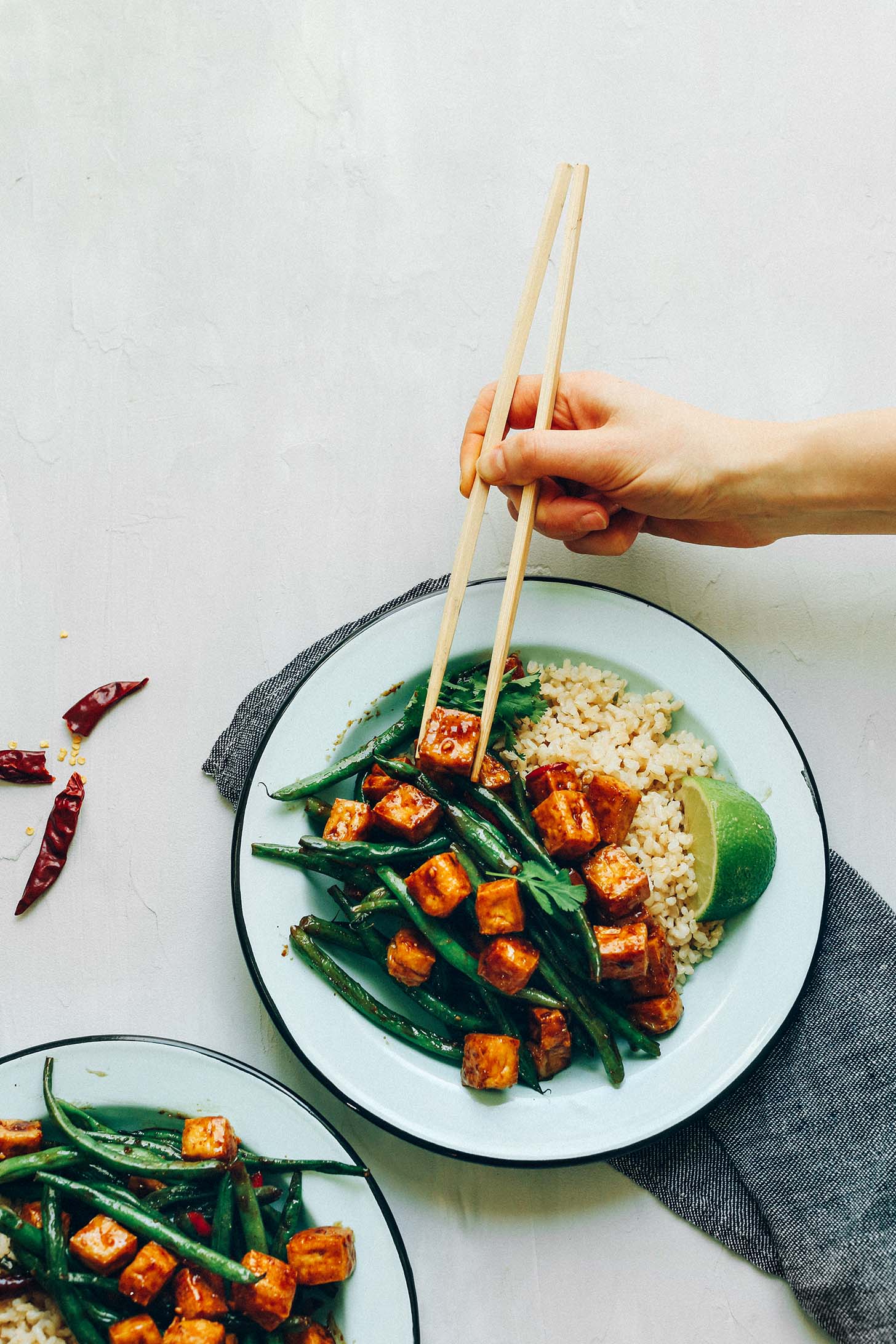 Using chopsticks to grab a bite of delicious and healthy Almond Butter Tofu Stir-Fry