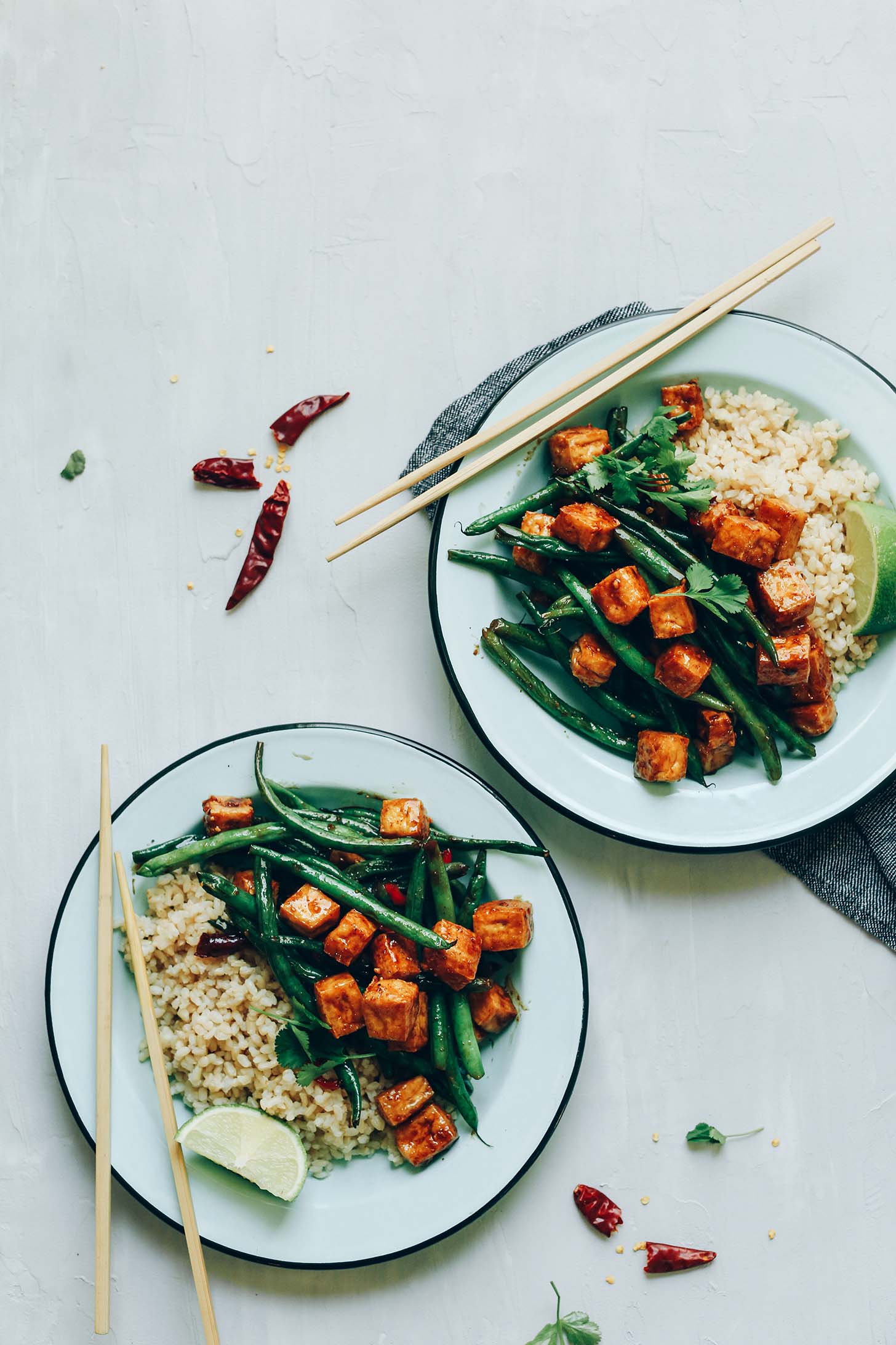 Two bowls of Almond Butter Tofu Stir-Fry with rice for a gluten-free vegan meal