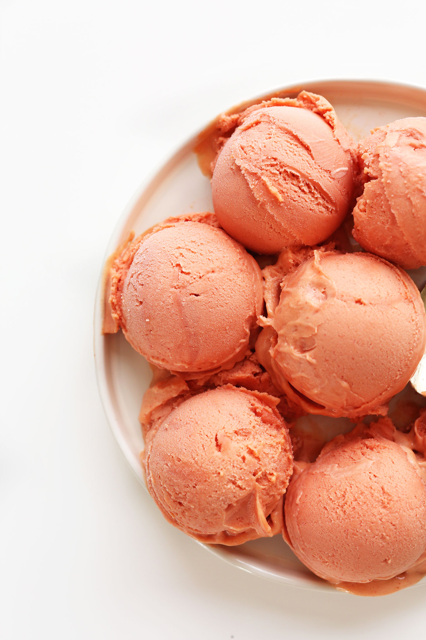 Scoops of Mango Raspberry Coconut Sorbet for a refreshing vegan summer dessert