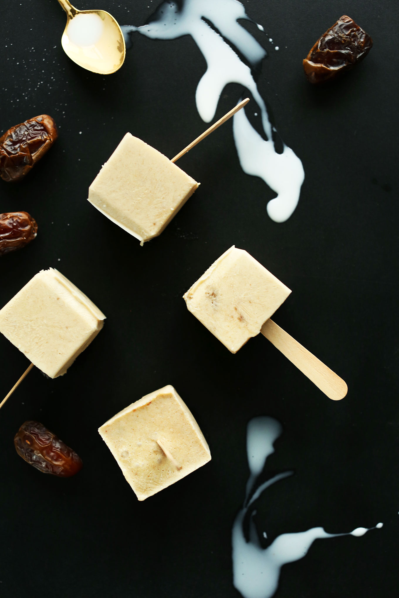 Salty and sweet Dulce De Leche Pops alongside date and spoons of coconut milk