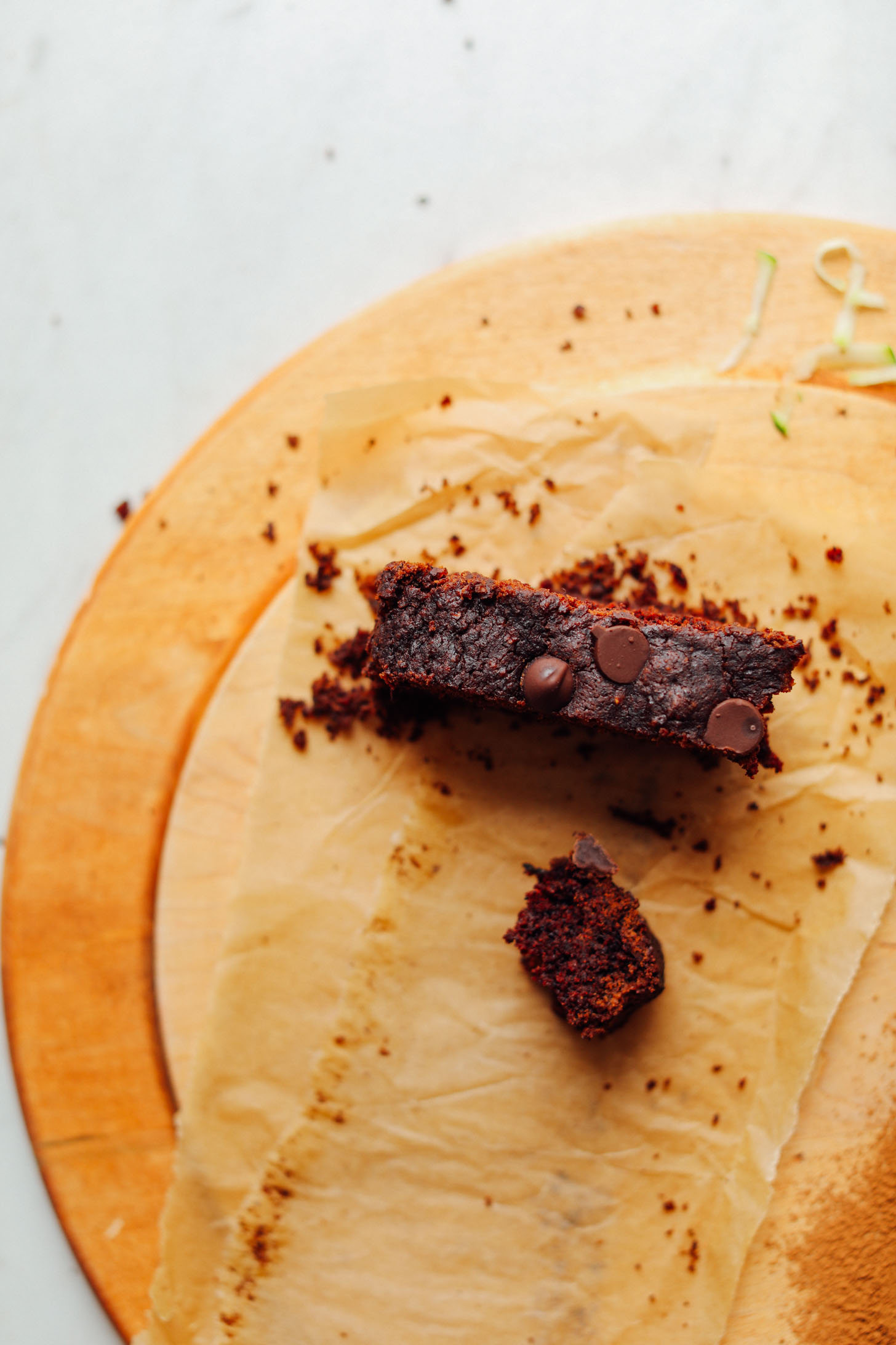 Slice of Vegan Chocolate Chip Zucchini Bread torn for taking a bite