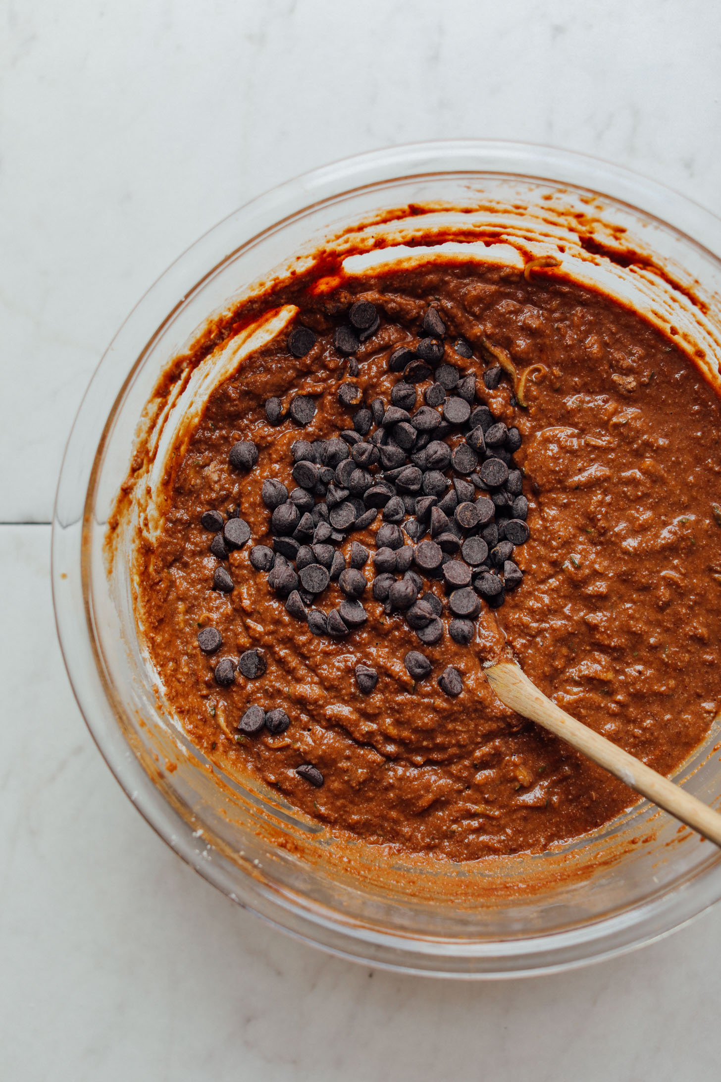 Stirring vegan chocolate chips into gluten-free Chocolate Chip Zucchini Bread batter