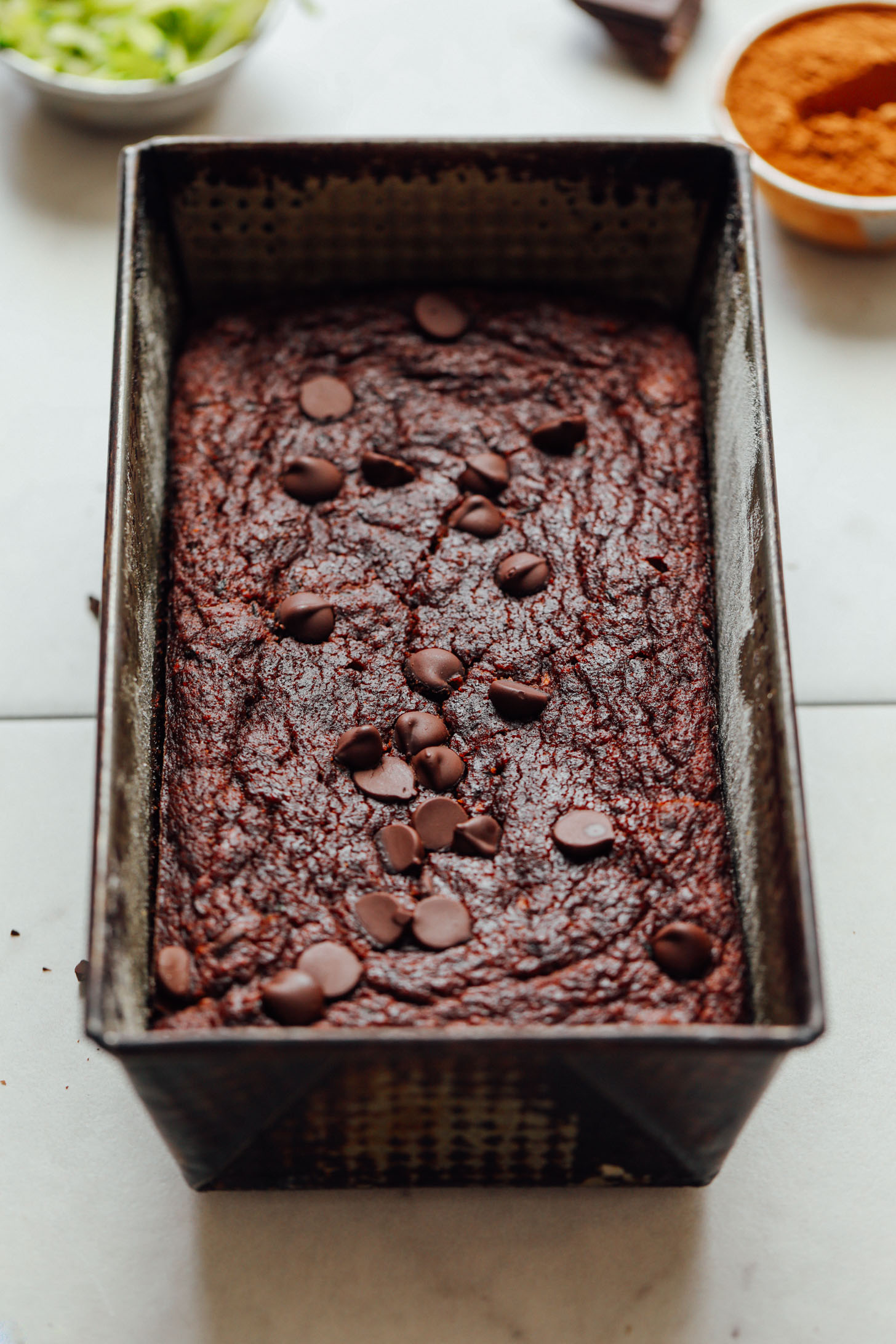 Metal bread pan with freshly baked Vegan Chocolate Chip Zucchini Bread