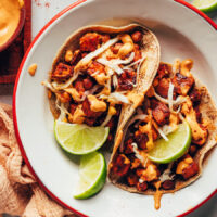 Overhead shot of a plate with two sweet potato chickpea tacos