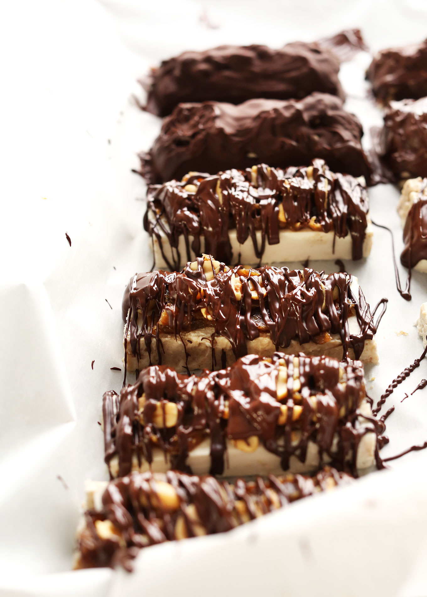 Vegan Ice Cream Snickers Bars freshly drizzled with dark chocolate