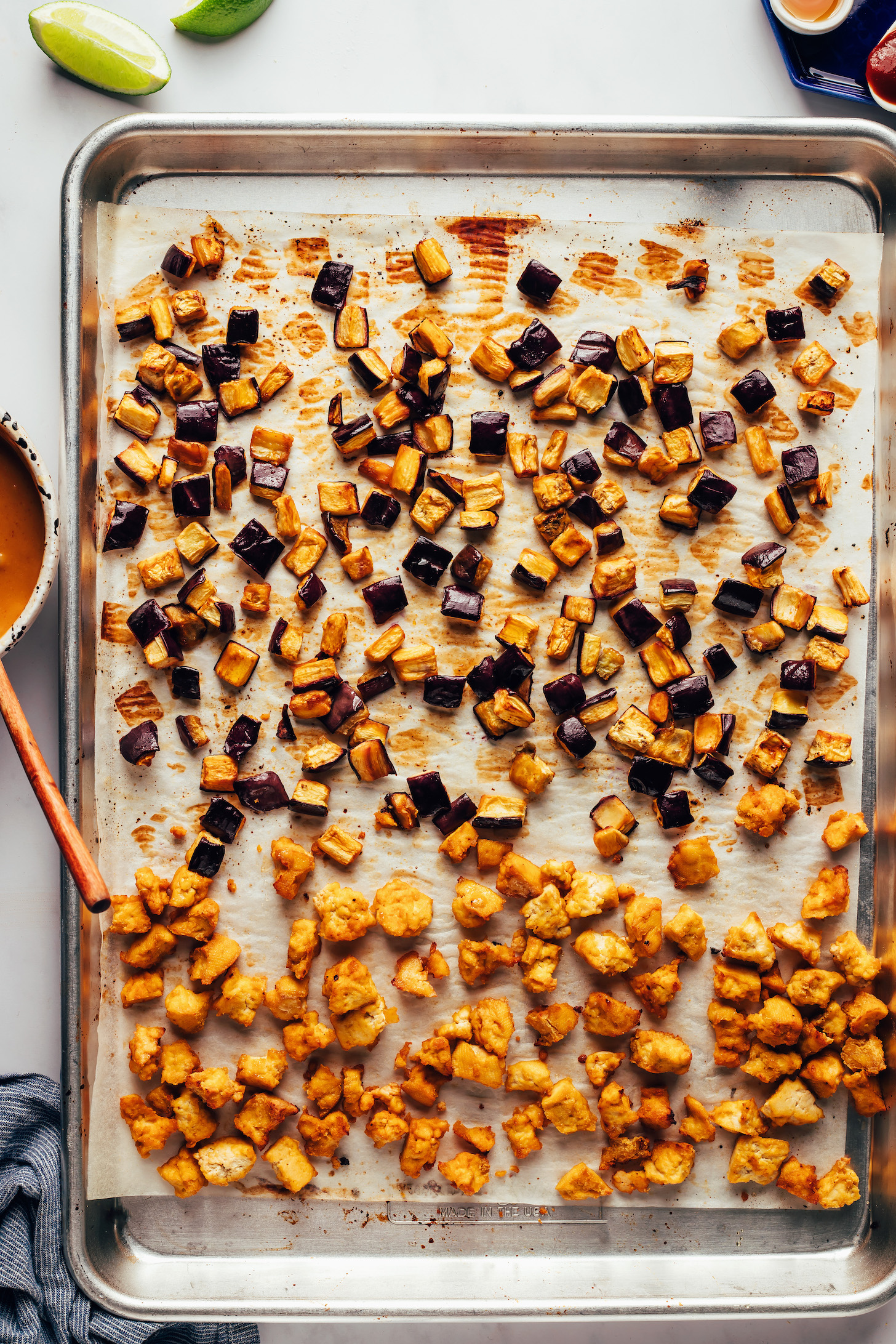 Cubed roasted eggplant and crispy baked tofu on a baking sheet