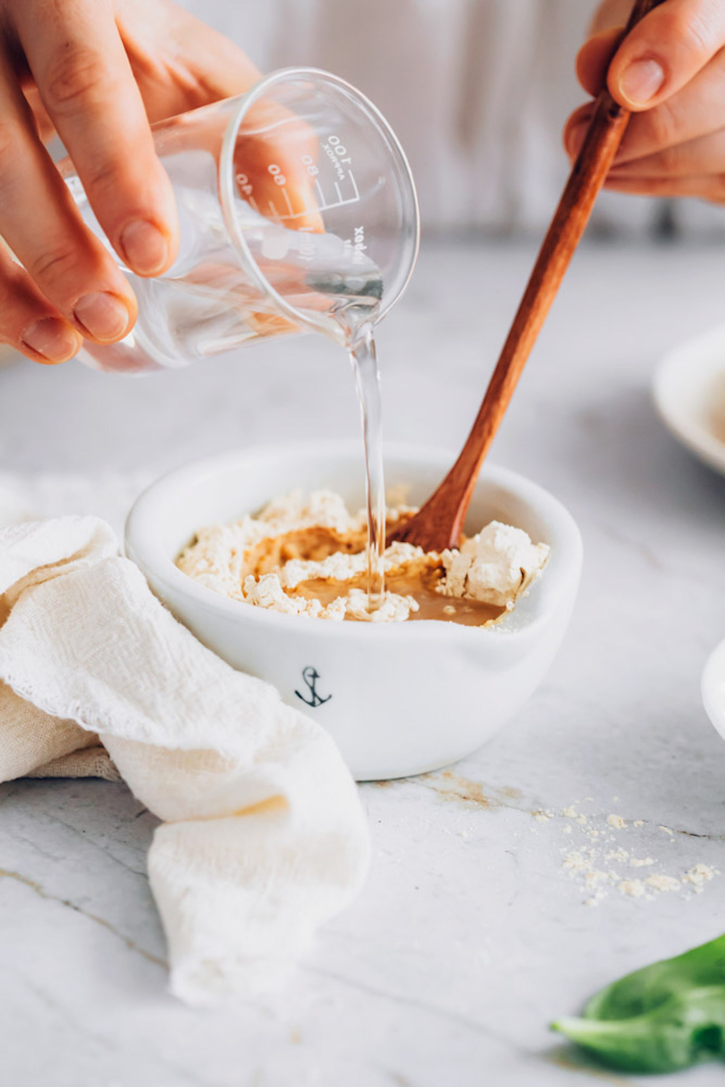 Mixing chickpea flour and water in a bowl