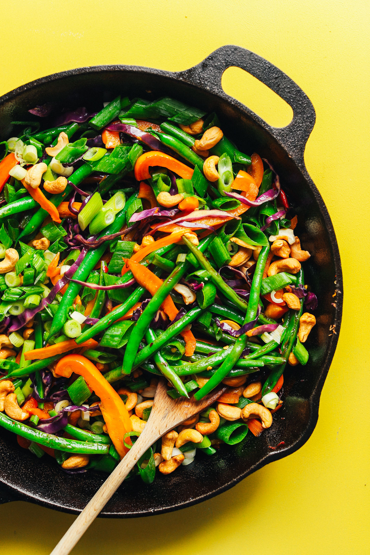 Cast iron skillet with colorful fresh vegetables for satisfying vegan Cauliflower Rice Stir Fry