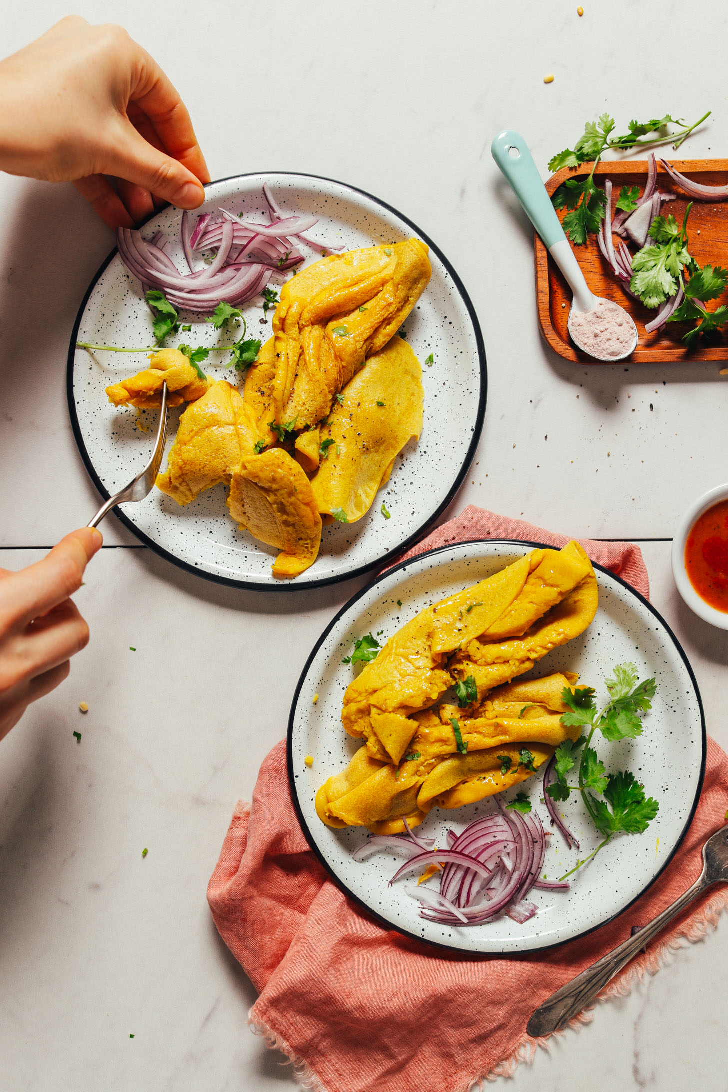 Using a fork to grab a bite of our fluffy vegan scrambled eggs recipe