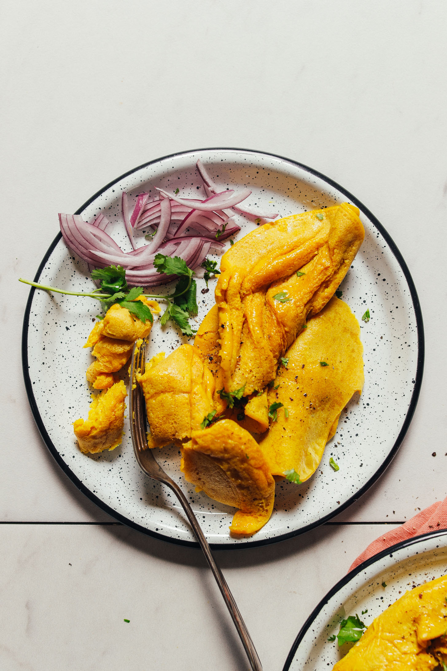 Using a fork to cut a bite of our delicious and simple vegan scrambled egg recipe