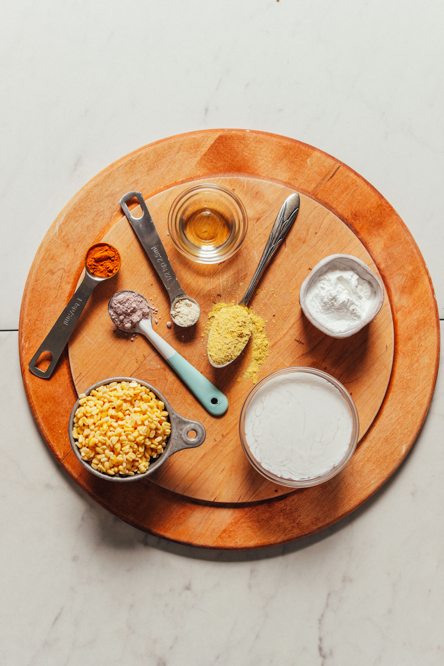 Wood cutting board with ingredients for making our fluffy vegan scrambled eggs made with mung beans