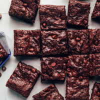 Overhead shot of our fudgy crackly top vegan gluten-free brownies on a piece of parchment paper