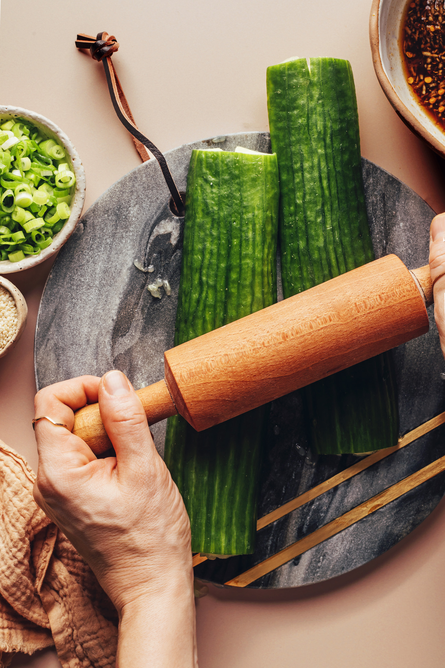 Using a rolling pin to smash cucumbers