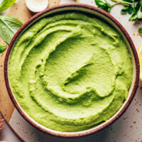 Overhead shot of a bowl of green goddess hummus