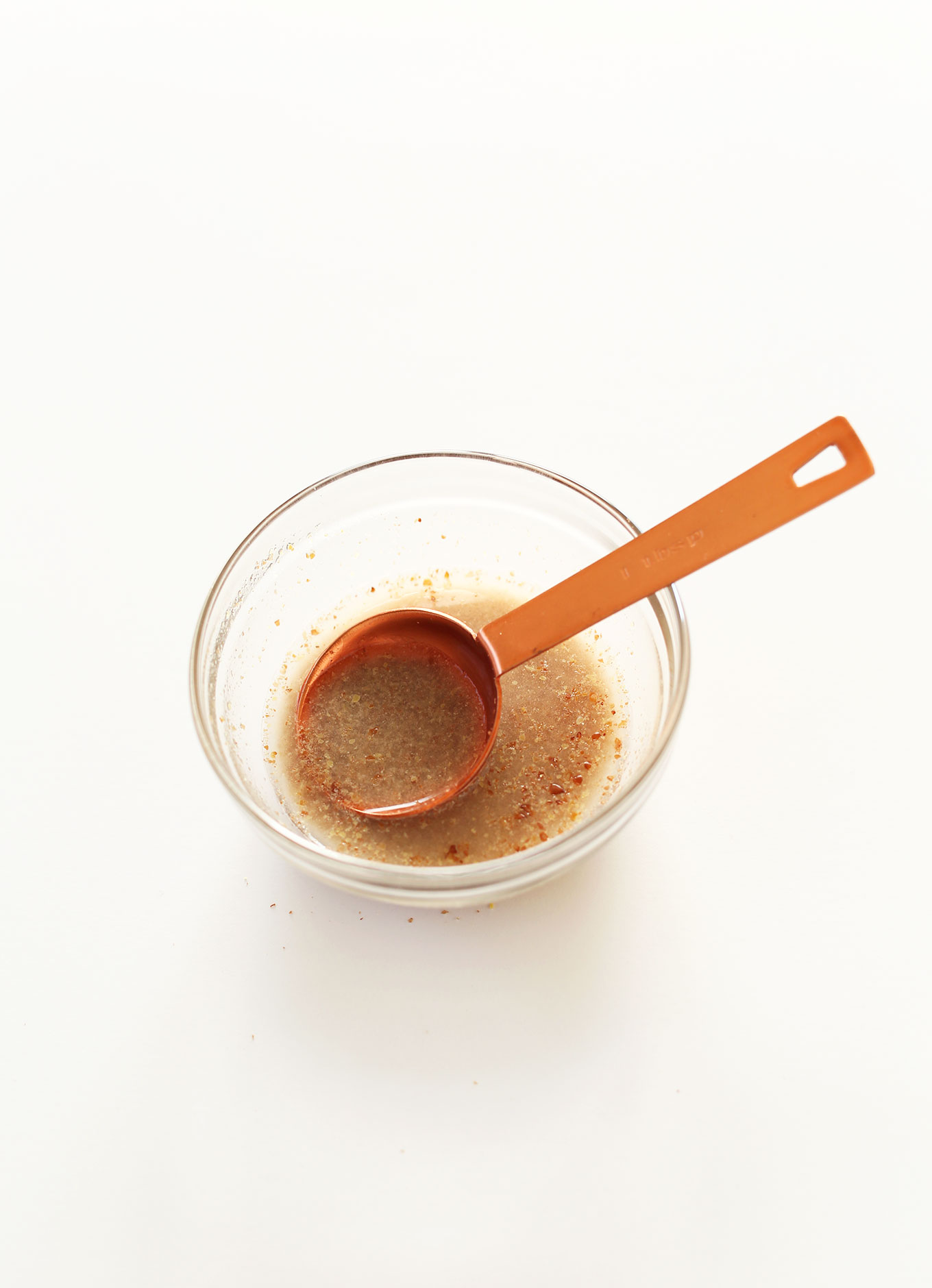 Measuring spoon in a bowl of flax egg