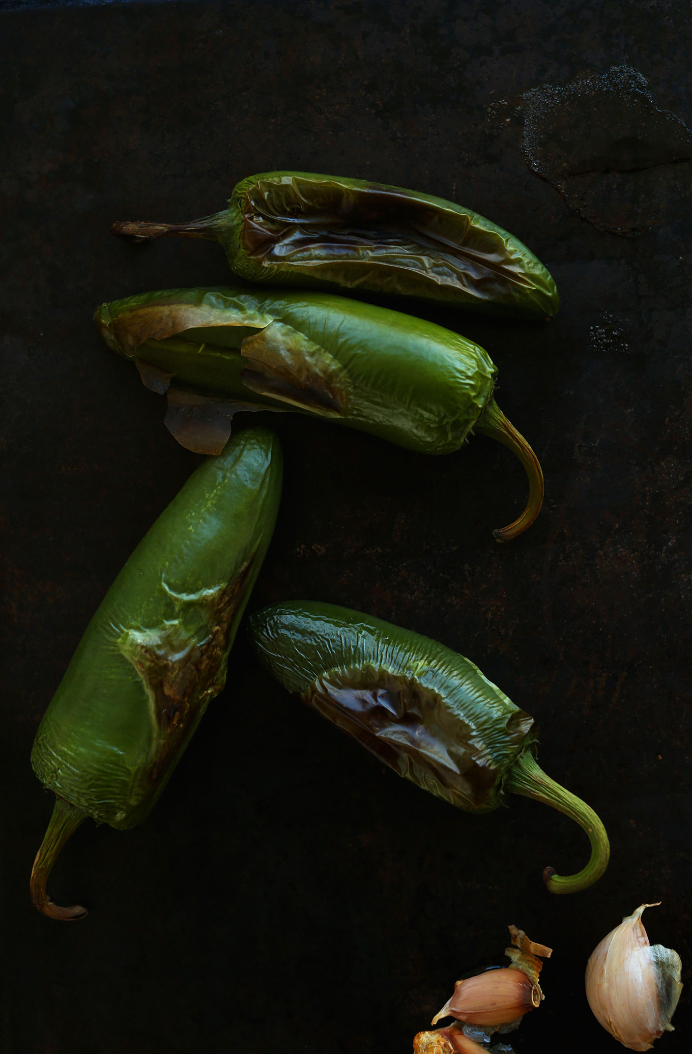 Baking sheet with freshly roasted jalapenos and garlic