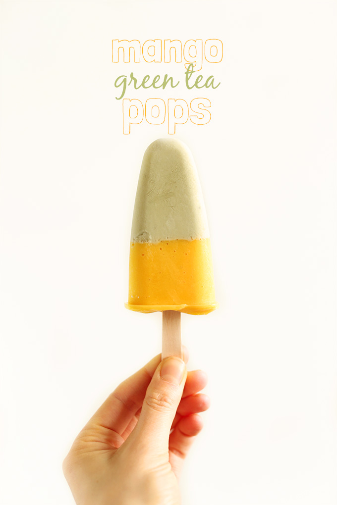 Holding up a vegan Mango Green Tea Pop with a mango layer and matcha layer