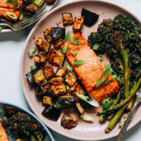 Plates of miso-glazed salmon, eggplant, and broccolini