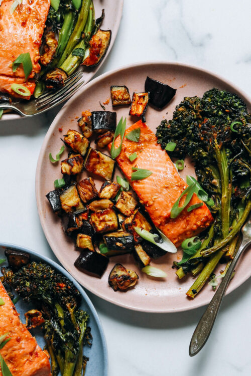 Plates of miso-glazed salmon, eggplant, and broccolini