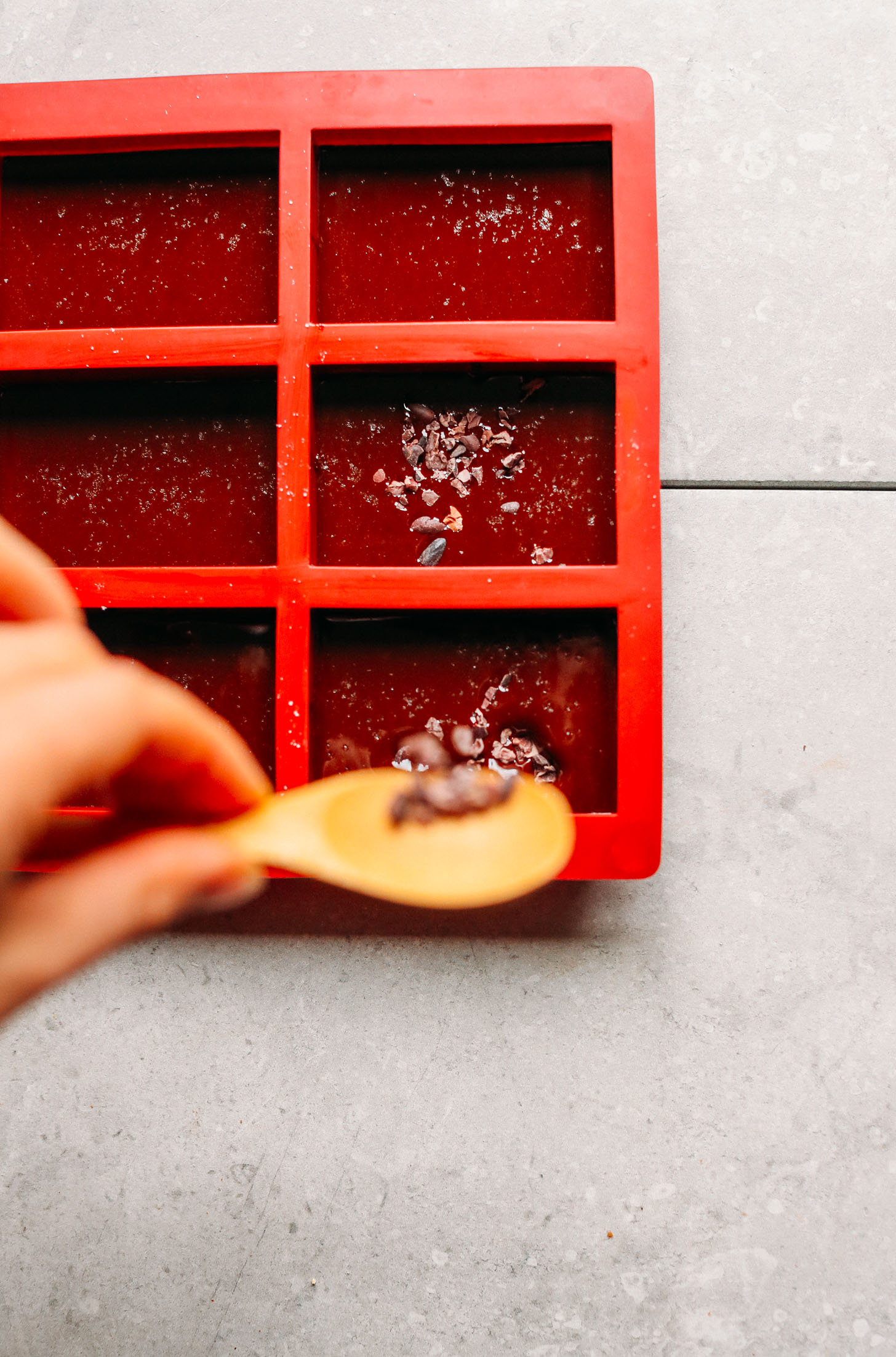 A silicone mold filled with melted chocolate for making homemade Vegan Dark Chocolate