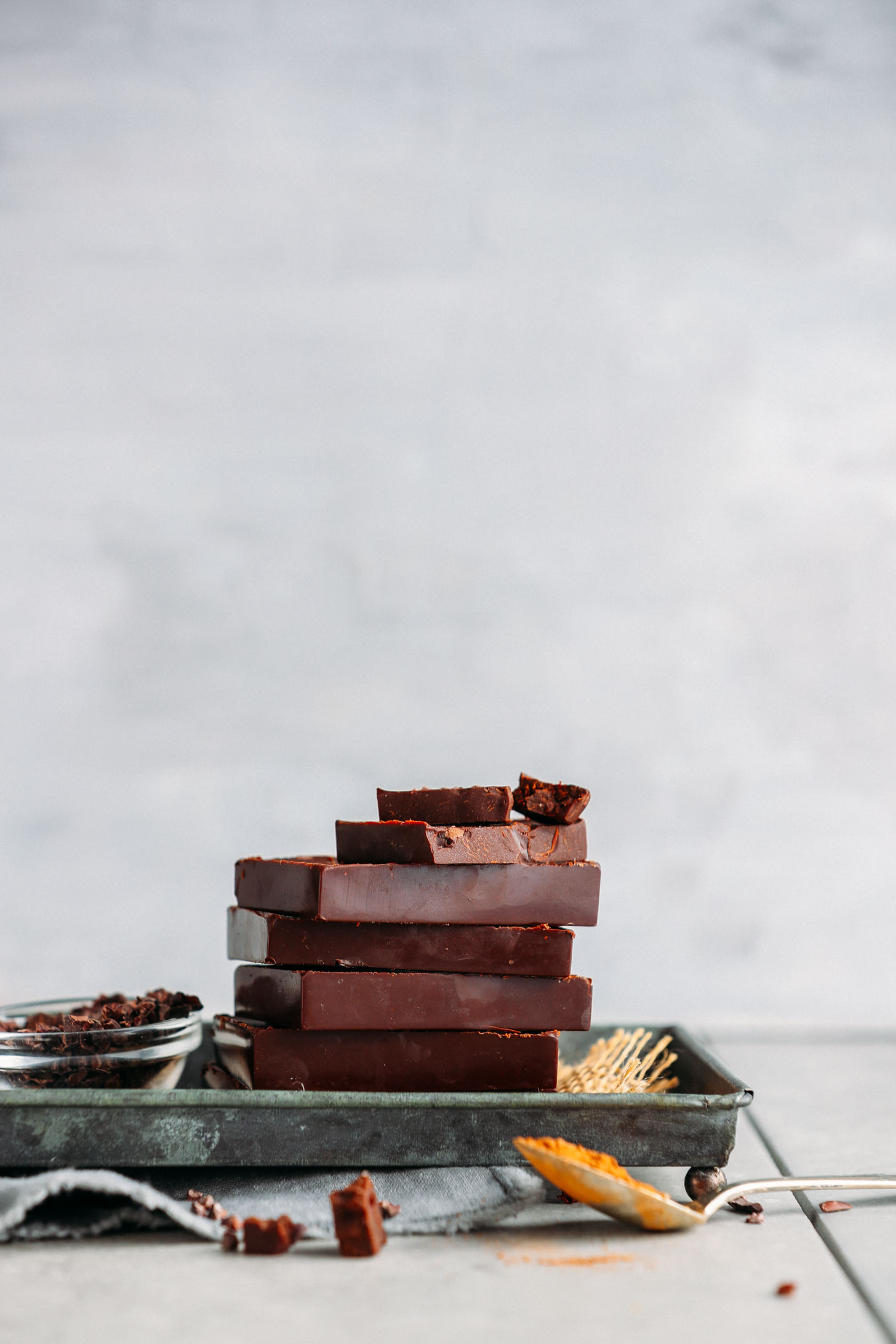 Stack of homemade Vegan Dark Chocolate bars on a metal platter