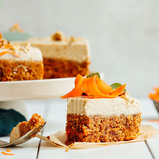 Partially eaten slice of Raw Carrot Cake resting beside the rest of the cake