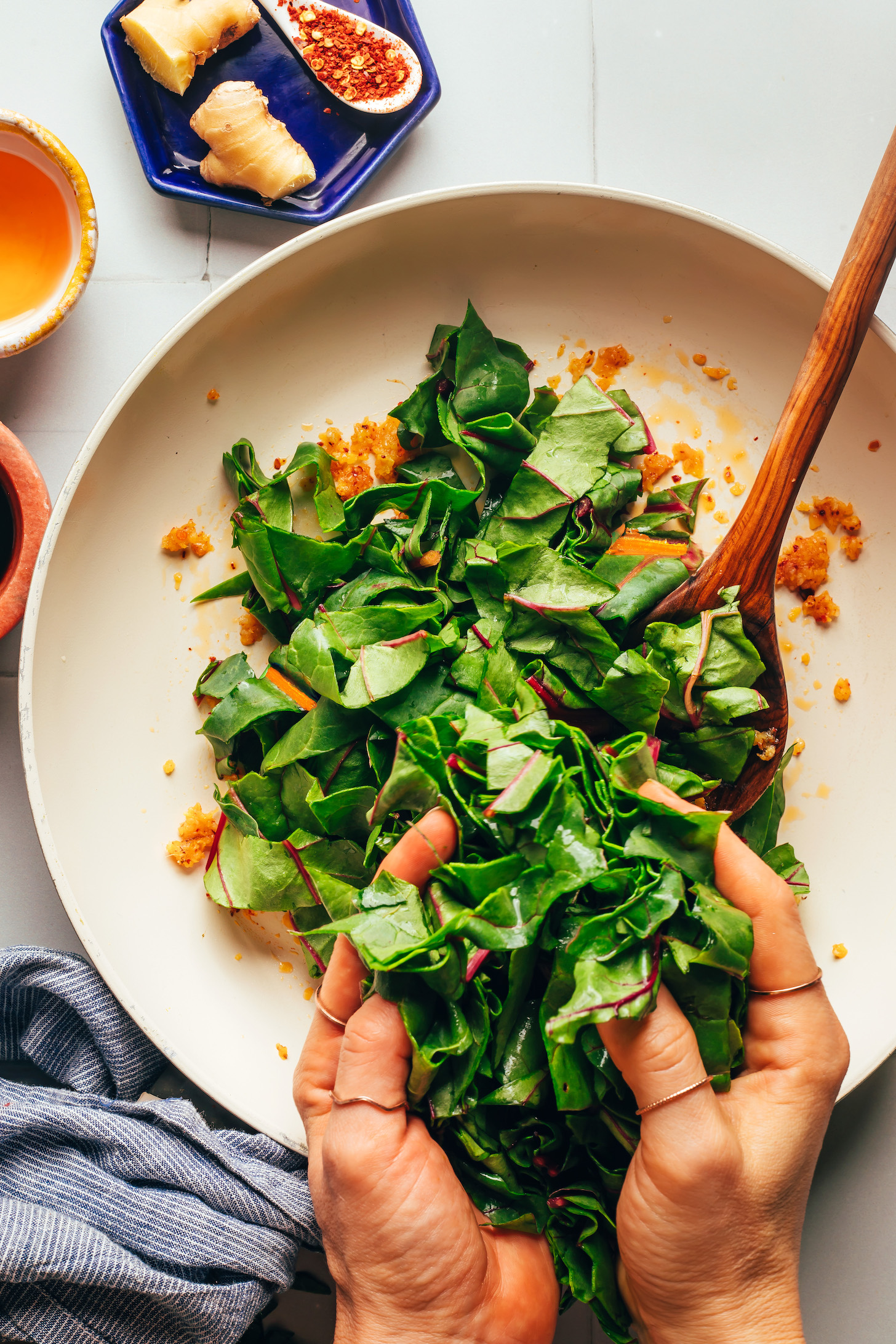 Adding chopped chard to a skillet of sautéed aromatics