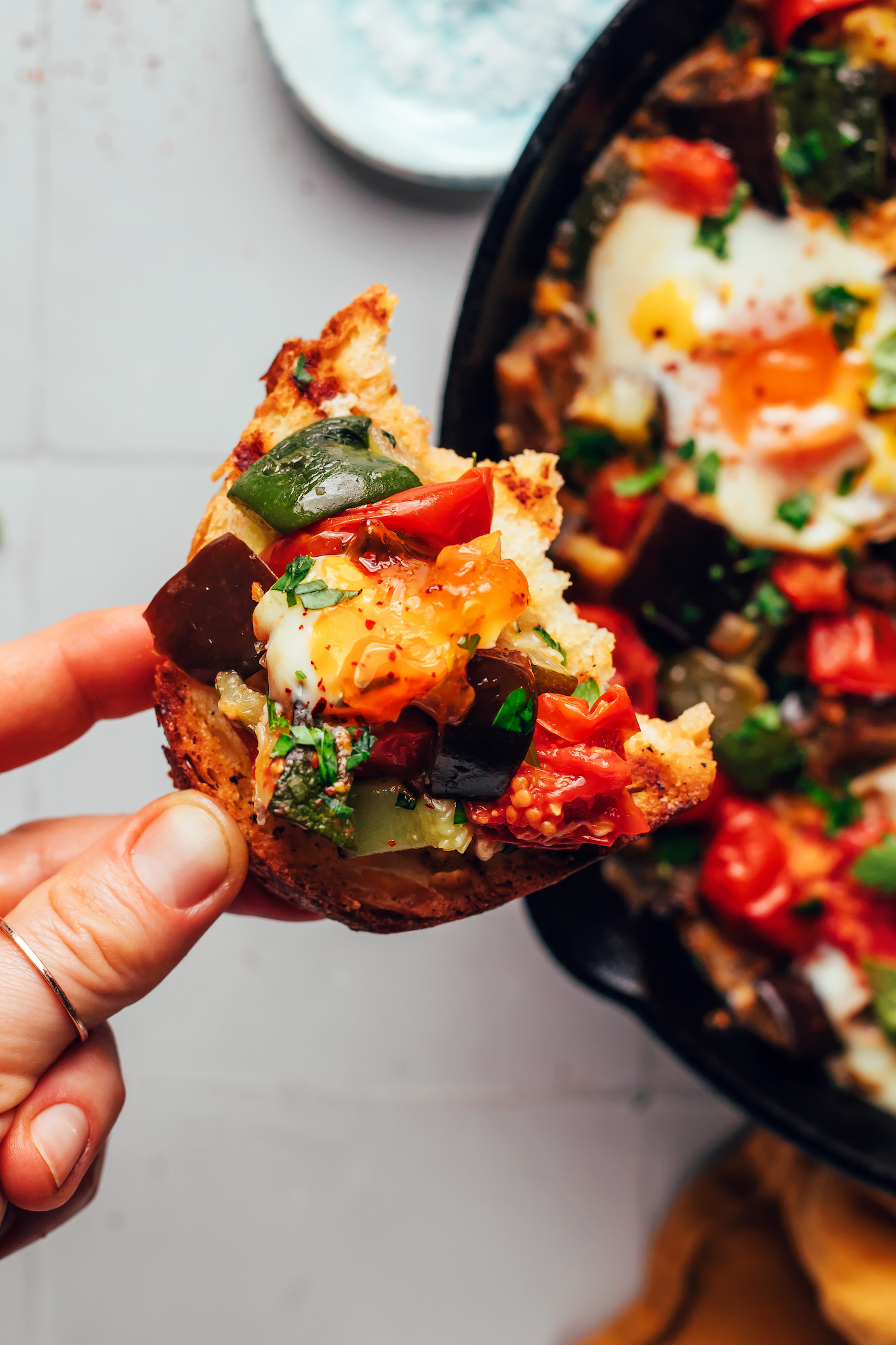 Slice of bread topped with sautéed veggies and egg