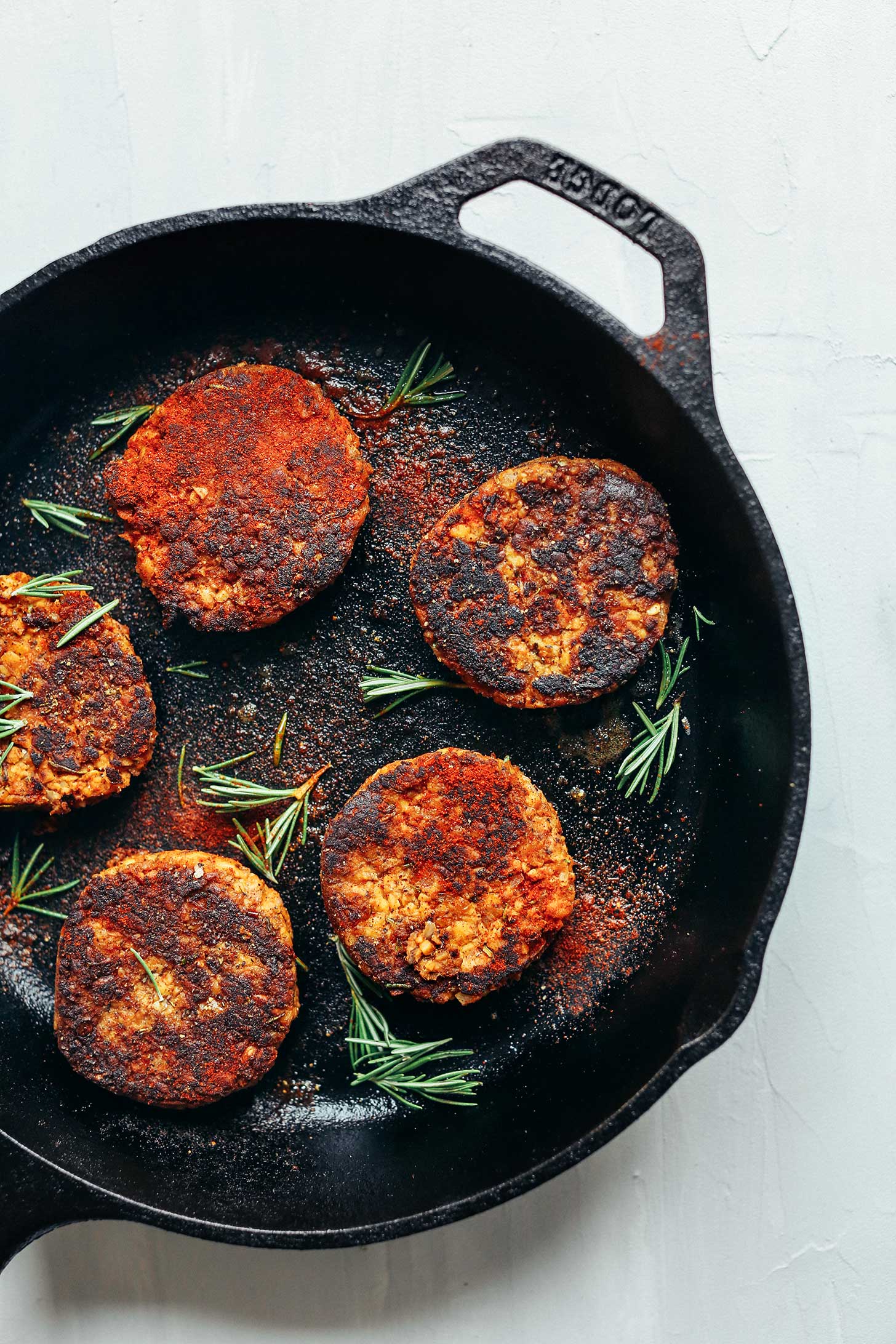 Cast-iron skillet filled with vegan sausages for a protein-rich plant-based breakfast