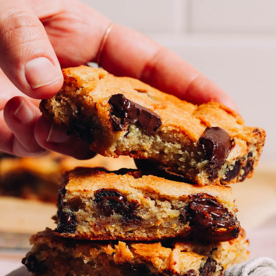 Picking up a sweet potato blondie from a stack