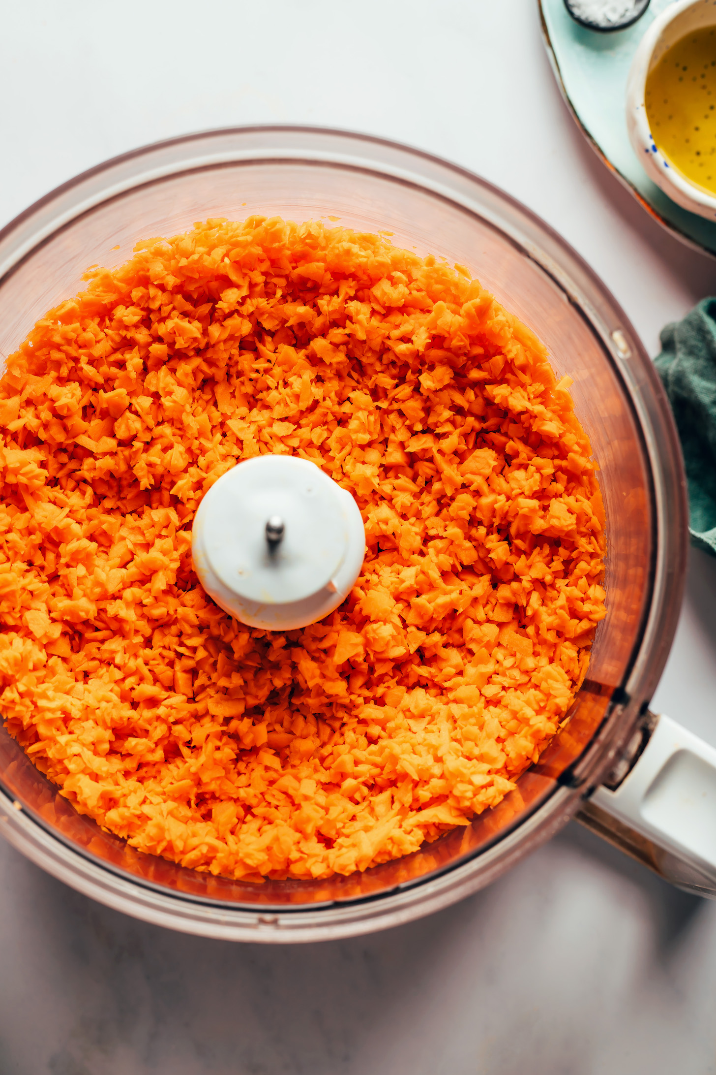 Sweet potato broken down into small pieces in a food processor