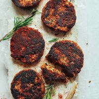 Spicy Tempeh Breakfast Sausages garnished with sprigs of fresh rosemary