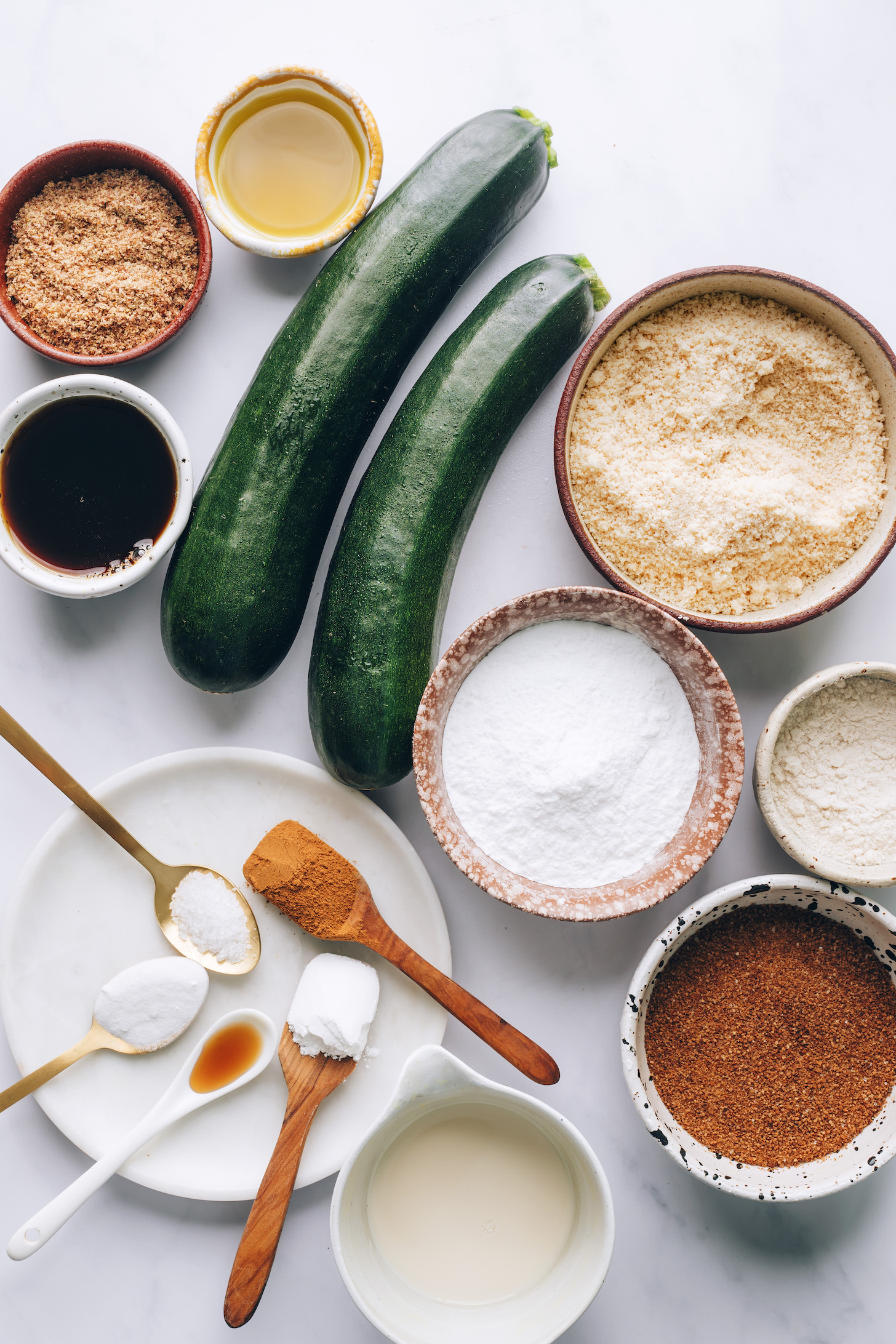 Flaxseed meal, avocado oil, zucchini, almond flour, potato starch, brown rice flour, coconut sugar, almond milk, baking soda, baking powder, cinnamon, salt, and maple syrup