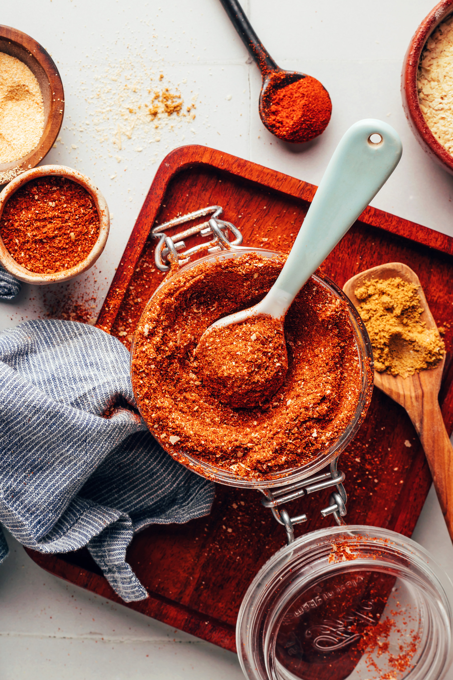 Overhead shot of a jar of homemade naturally sweetened taco seasoning next to ingredients used to make it