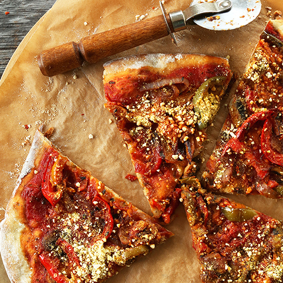 Slices of Vegan Pizza on a parchment-lined plate