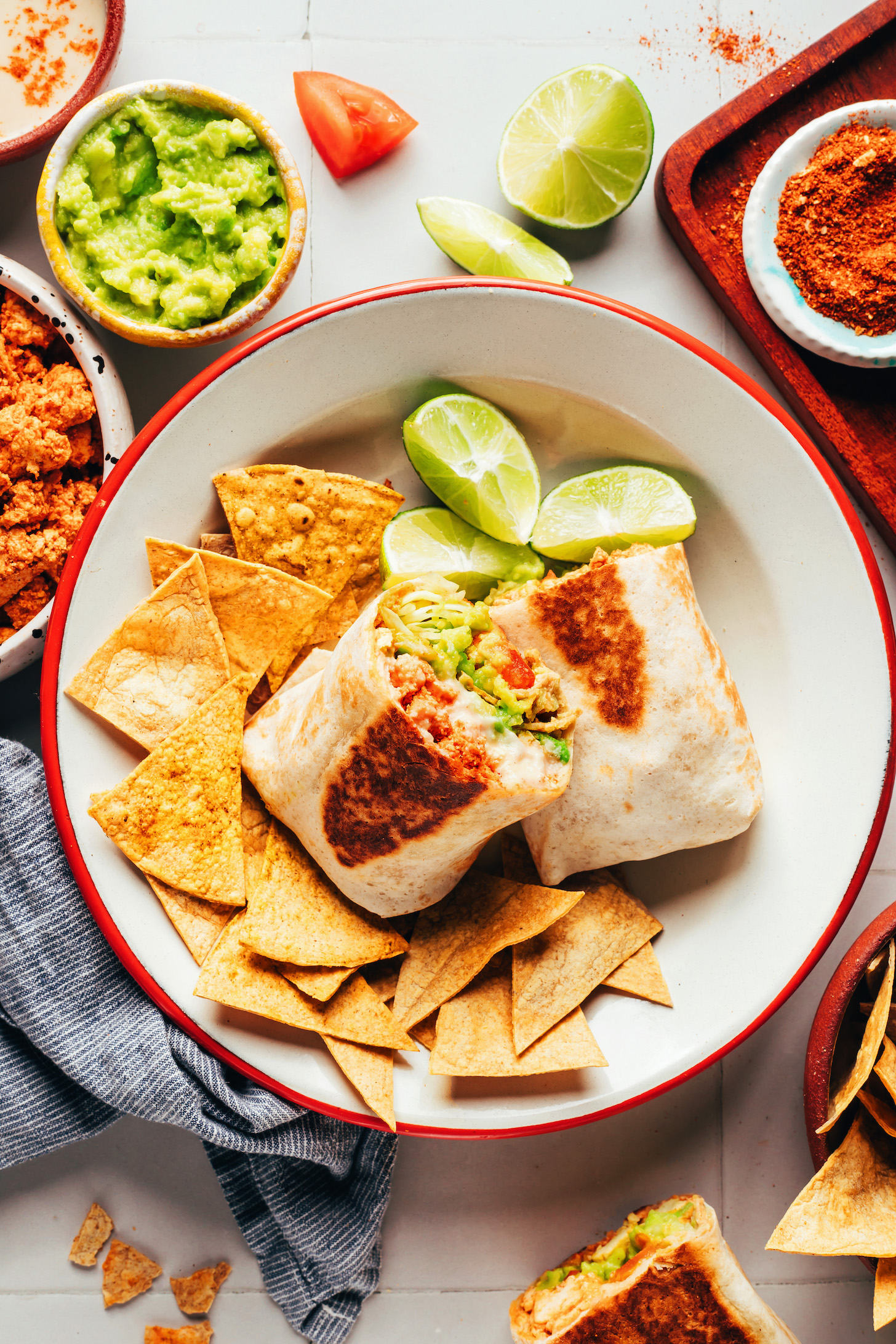 Bowl with a burrito cut in half and served with tortilla chips